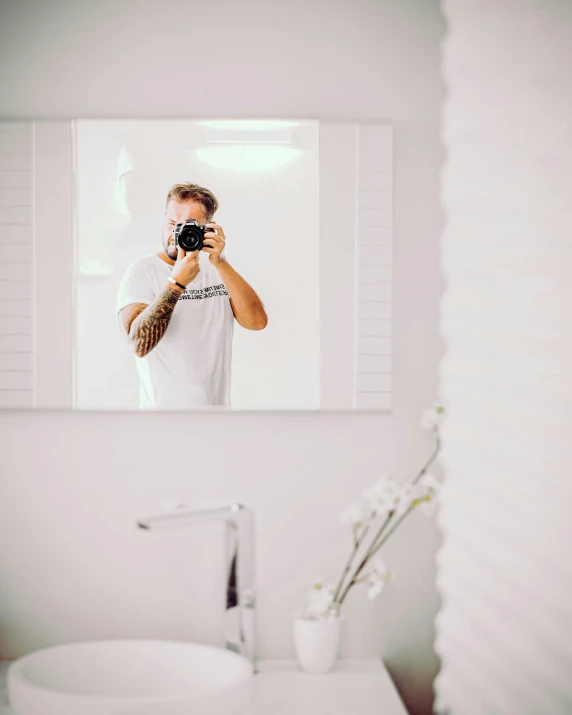 man taking po of himself in bathroom mirror