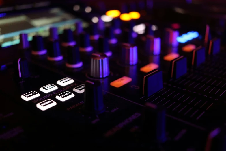 a close up view of ons on a djs mixing console