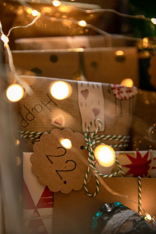 wrapped gift boxes with strings on them and string lights