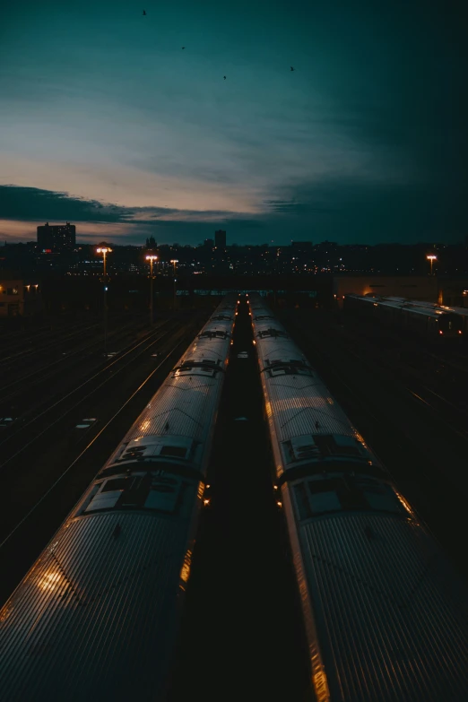 train tracks at night with train on both side