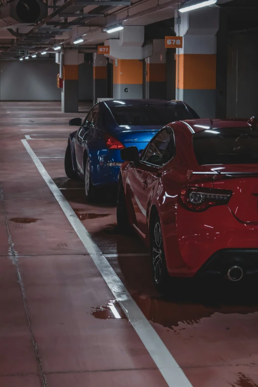 two cars parked in a garage during the day