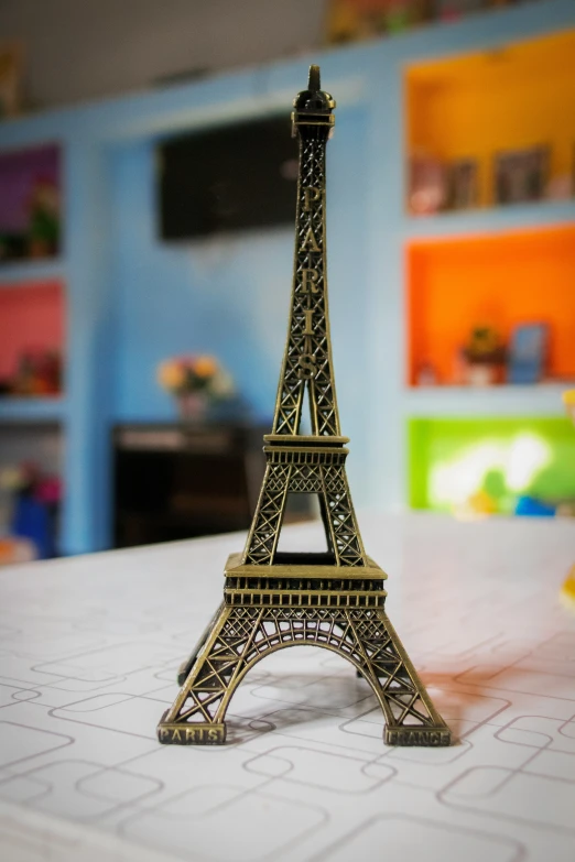 a toy model of the eiffel tower on a desk