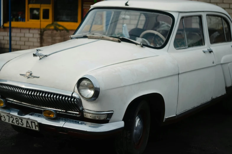 an old car with a white top and black tires