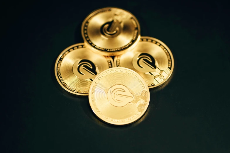 three golden bitcoins sitting on top of each other