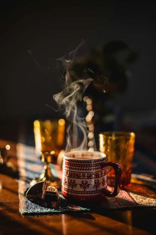 there is some steam coming out of the cup on this table