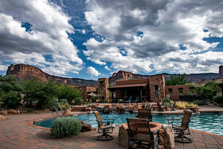 some chairs a pool and some mountains