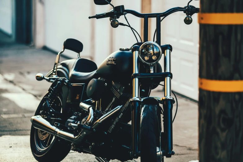 a motorcycle is parked in front of a pole