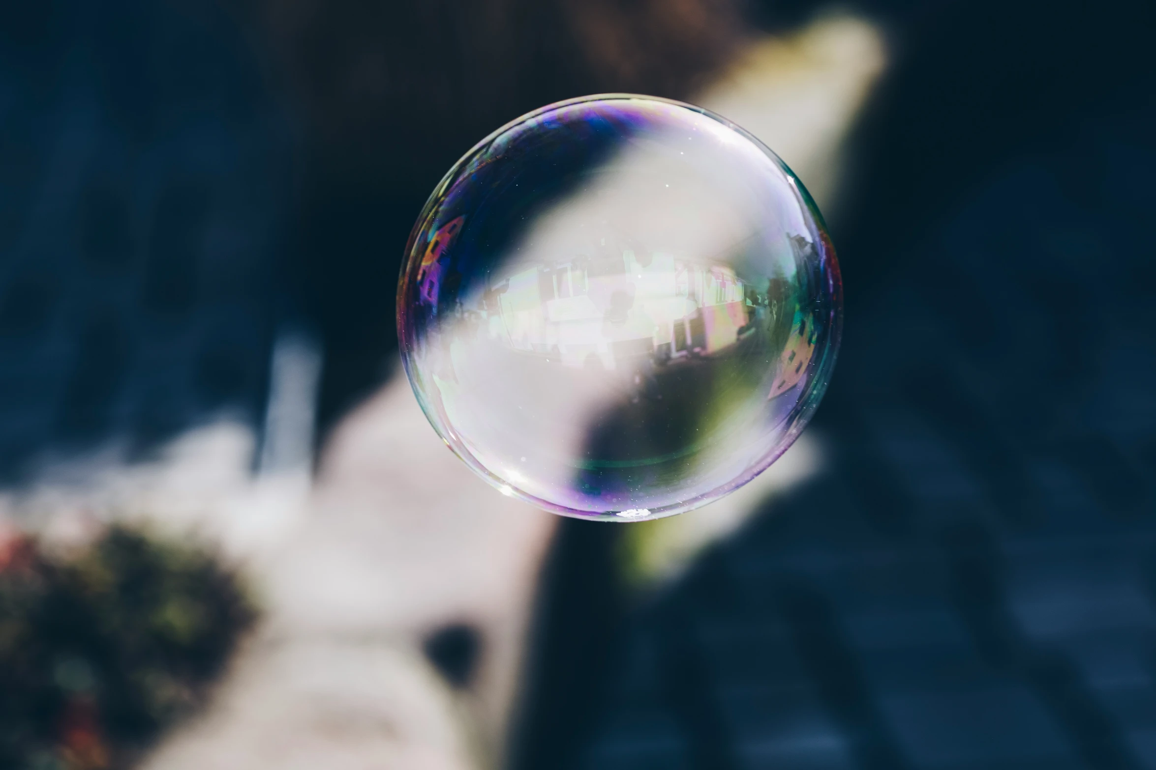 a girl holding a soap bubble in her hand