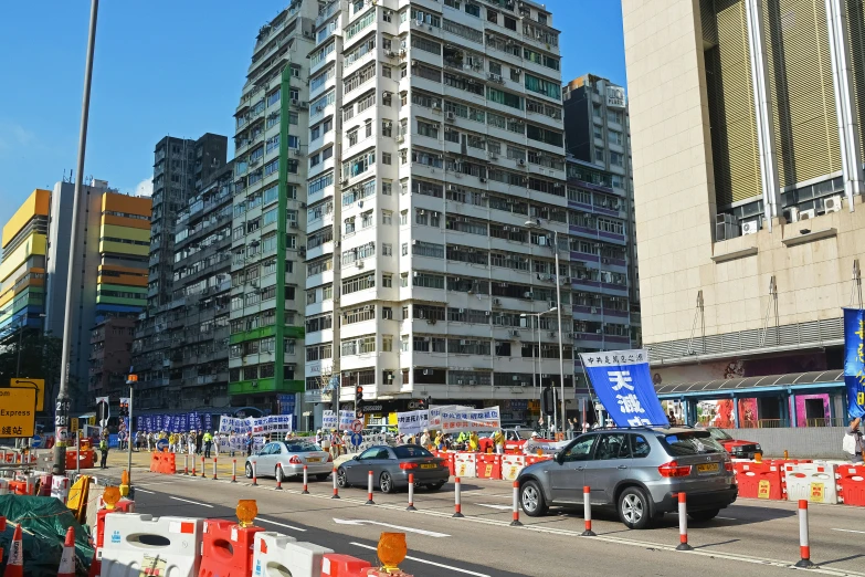 cars going down a street with buildings near by