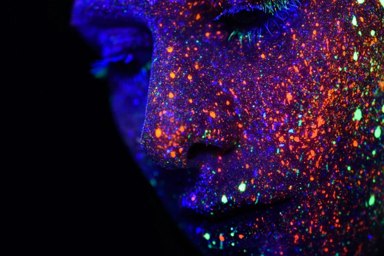 a close up s of a face with colorful glowing skin