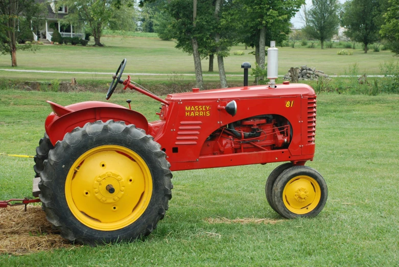 a vintage tractor is parked in the grass