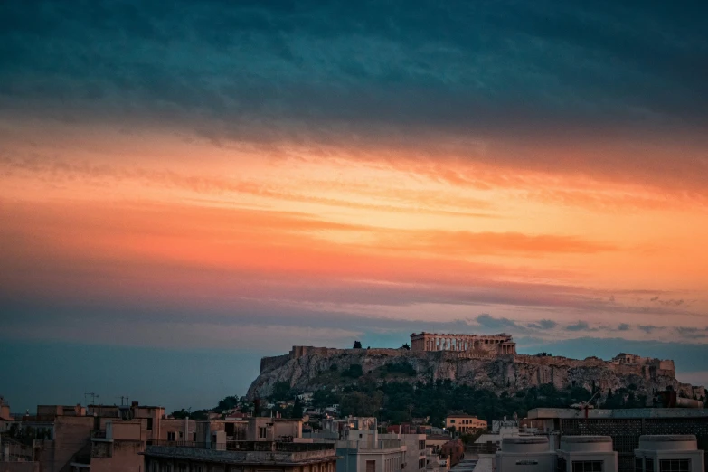 the ruins of a very large city at sunset