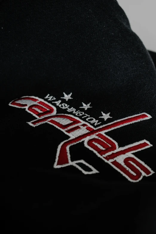 a close up image of a hoodie with an american flag and a red and white baseball bat