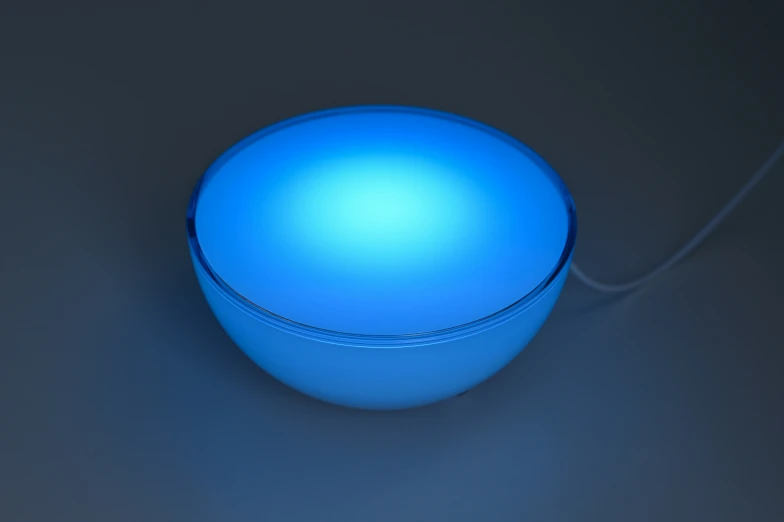 a bright blue sphere like device sitting on a table