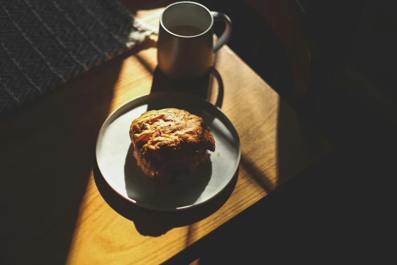 a cookie is next to a coffee cup on the table