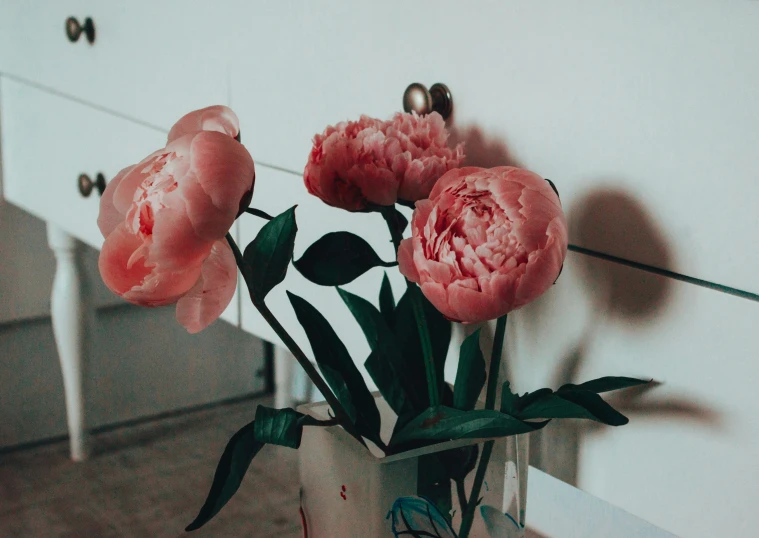 a few pink flowers in a small vase