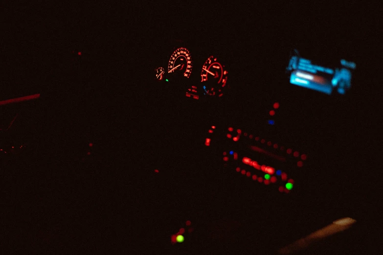 some lights in the dashboard of a car at night