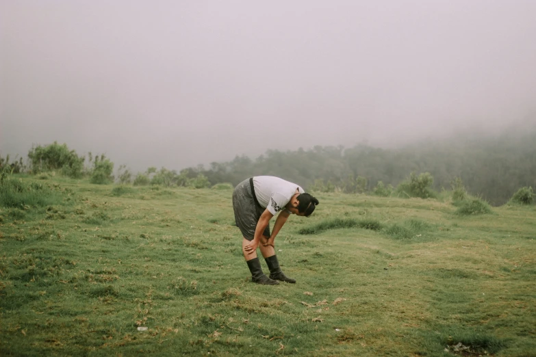 a man wearing boots in an open field