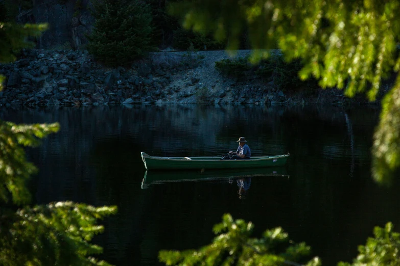 a person in a boat on a lake