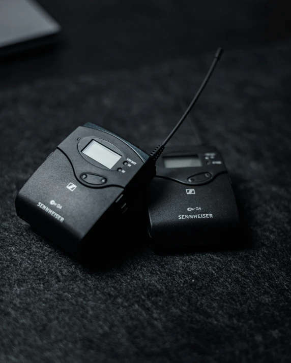 a close up of two electronic gadgets on a table