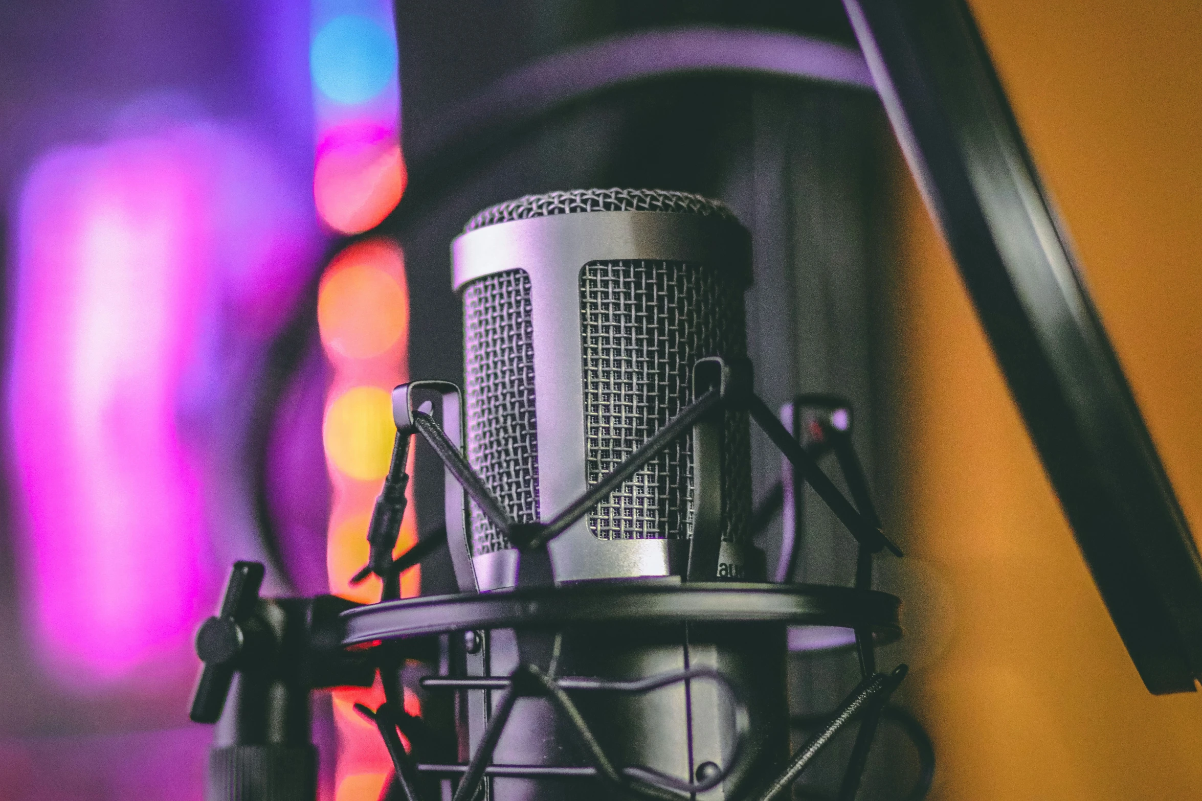 a black microphone is sitting on a purple and orange background