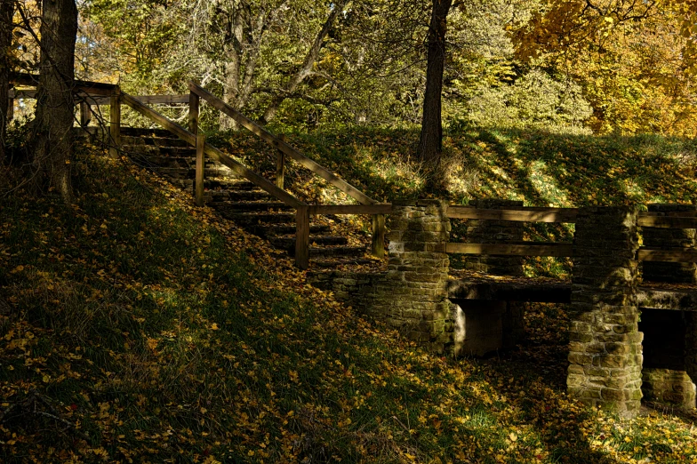 an old bridge that has a ramp leading uphill to it