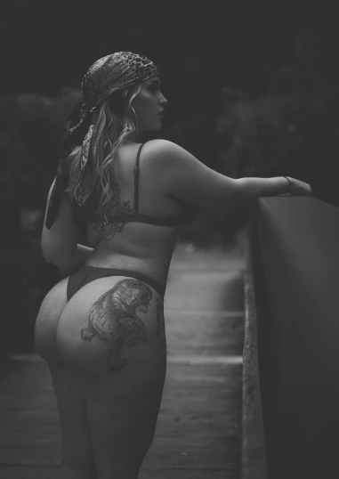 black and white po of woman with a tattoo