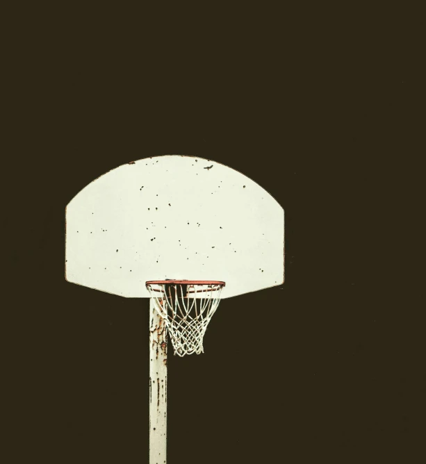 an old white basketball goal with a black background