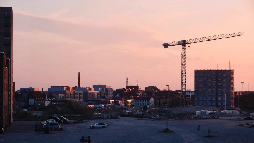 a building site with two cranes in the background