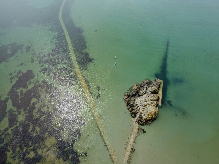 an old broken boat sits at the shore