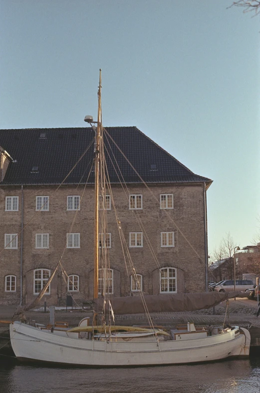 a sail boat sitting in front of an old building