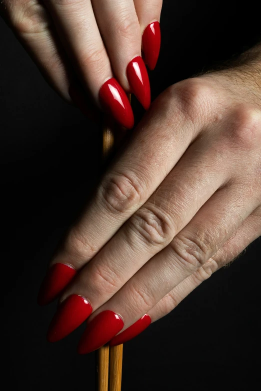 a person's hand with a manicured mani and long nail