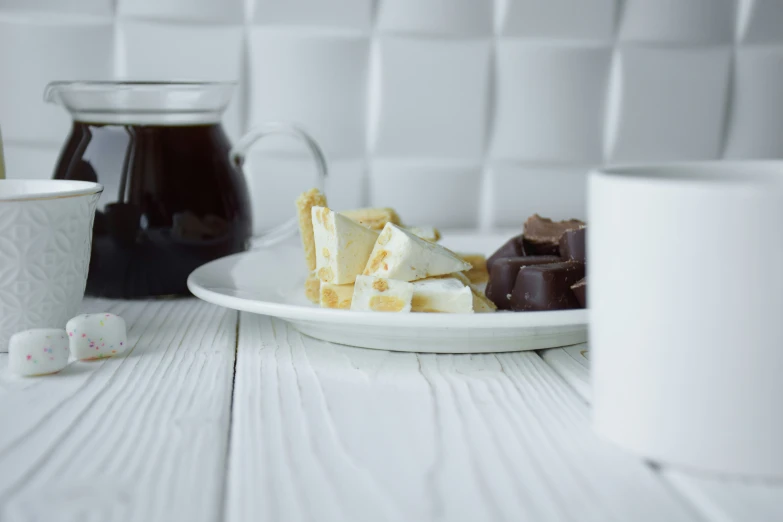 some kind of food on a white plate and cup