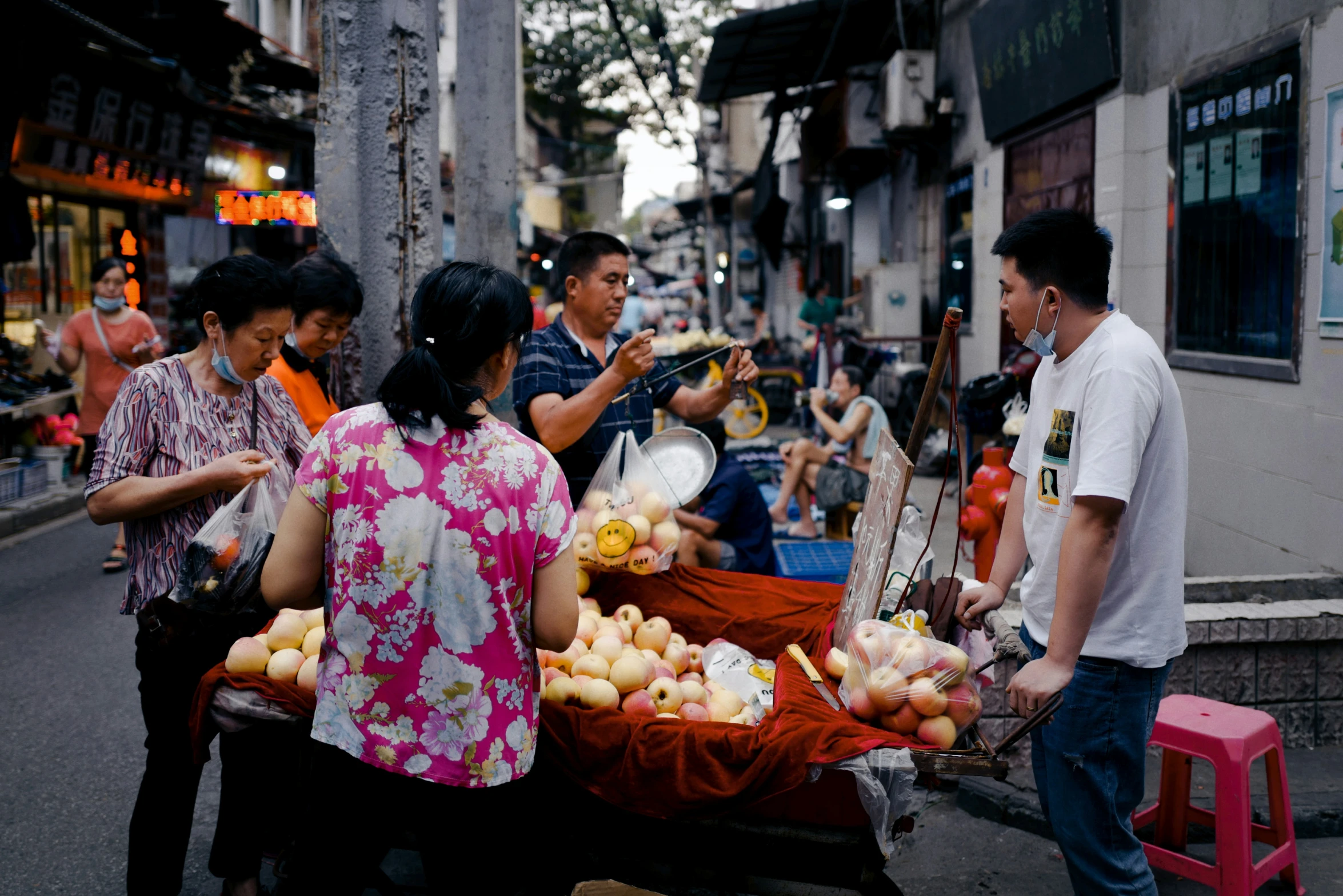 a group of people selling fruit from carts