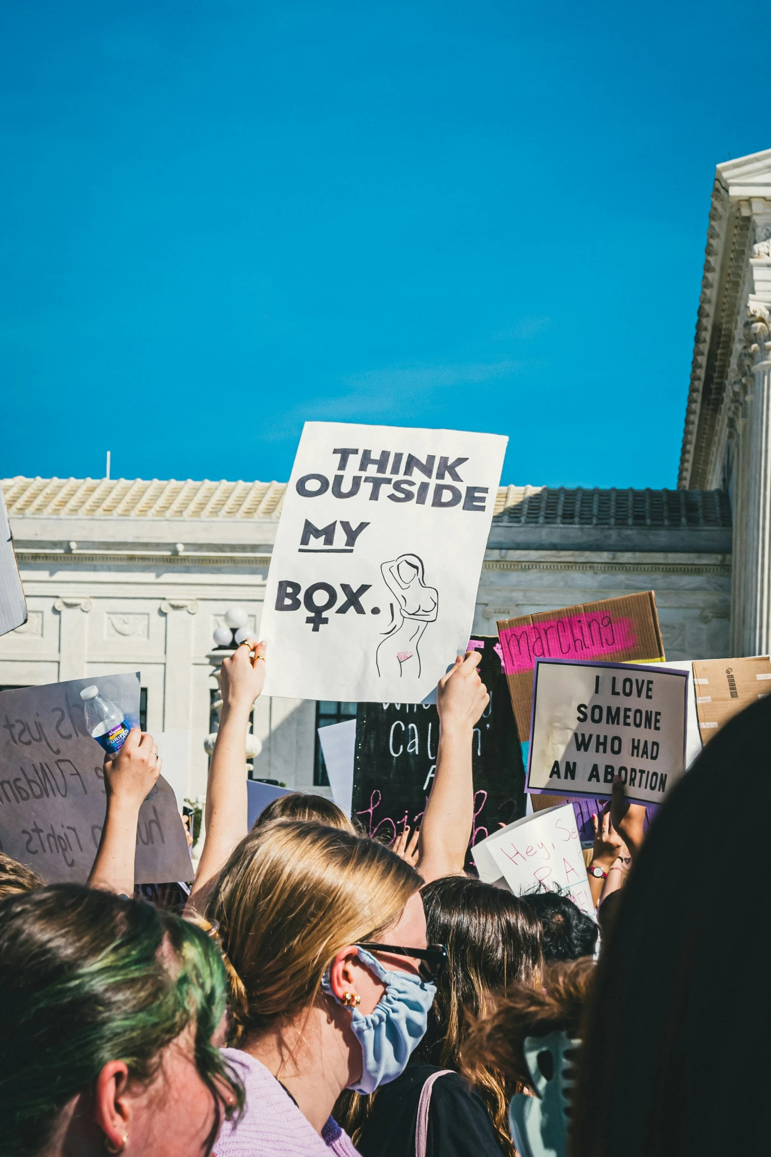 several people holding up signs outside a courthouse