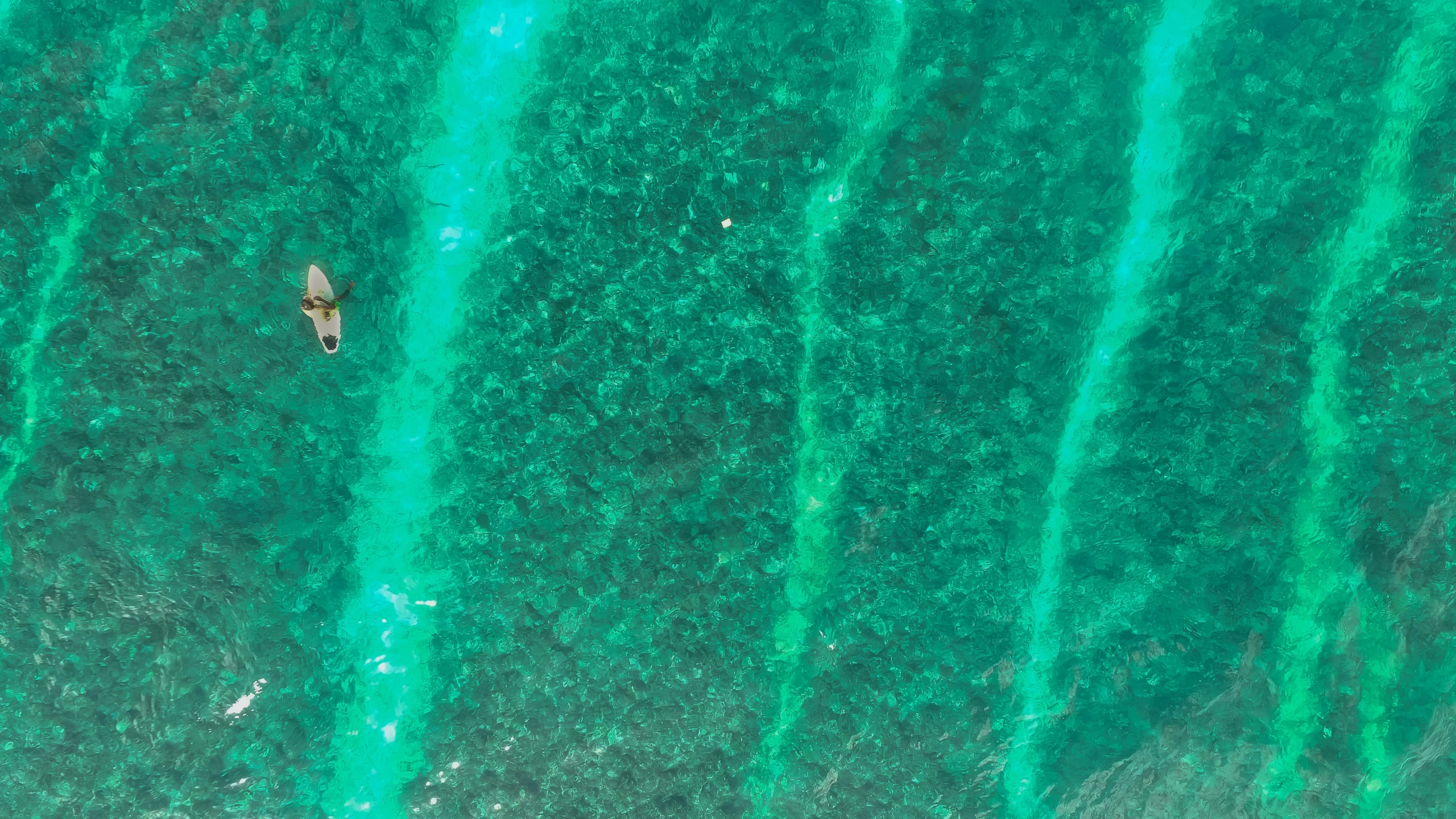 a man on a surfboard riding the ocean waves