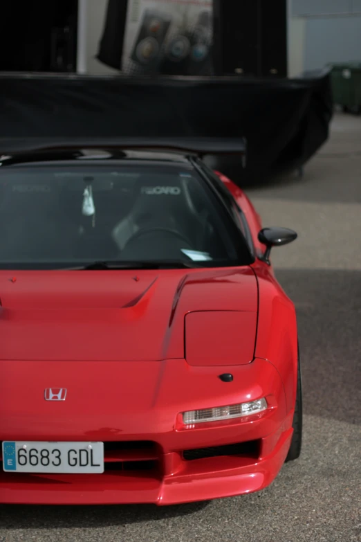 a car is red in color on a city street