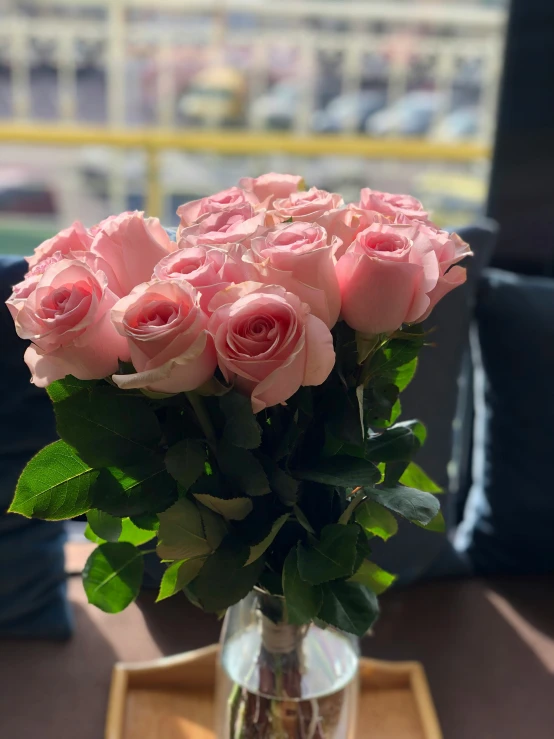 a bouquet of pink roses are in a vase