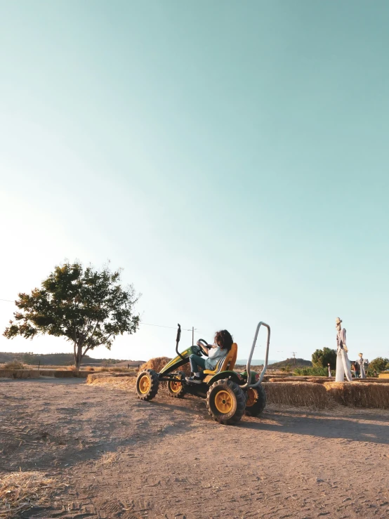 a man driving a tractor in the field