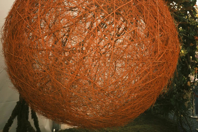 a orange colored ball that has many strings on it