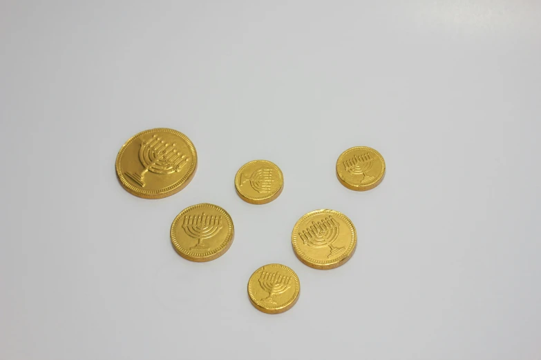 six different types of coins on a white surface