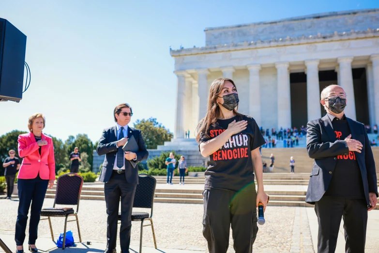 woman in front of lincoln memorial wearing masks