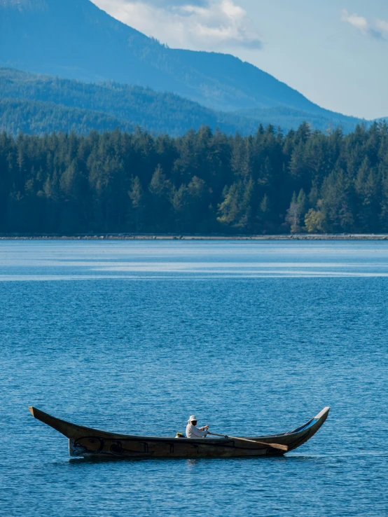 there is a man in a boat out on the water