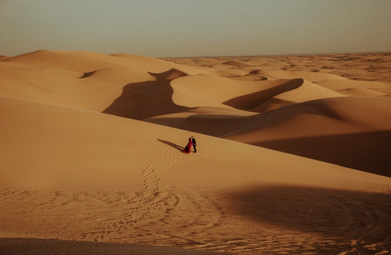 a woman is walking in the sand