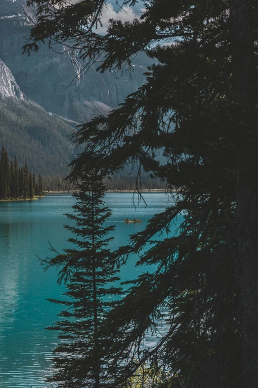 a boat in a lake near some mountains