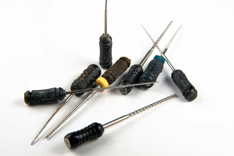 several small needles with various colored pins