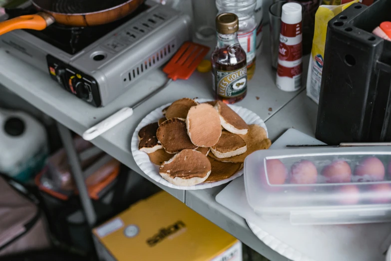 a table with a pile of hamburgers on top of it