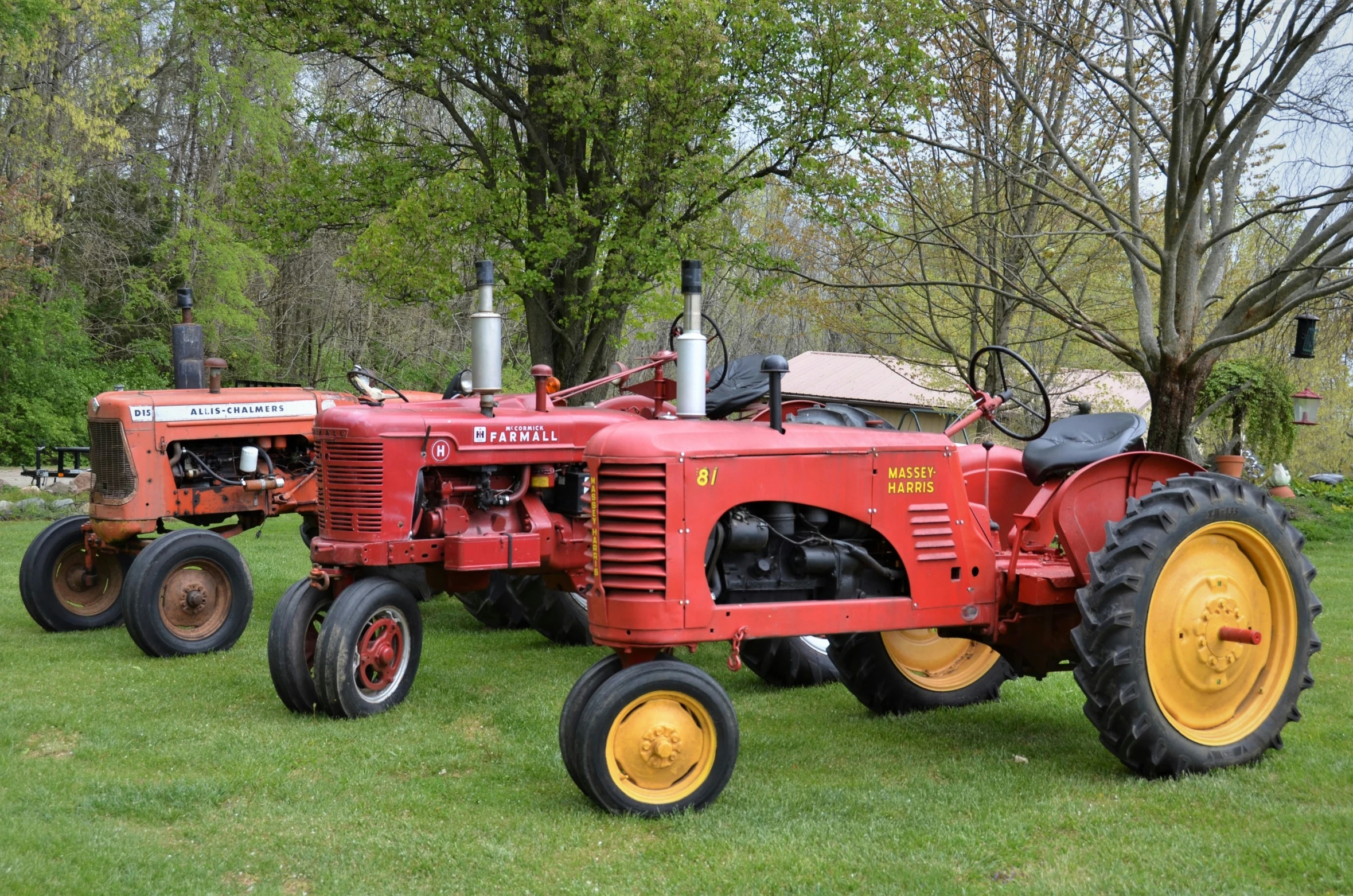 an old tractor sitting in a grassy field