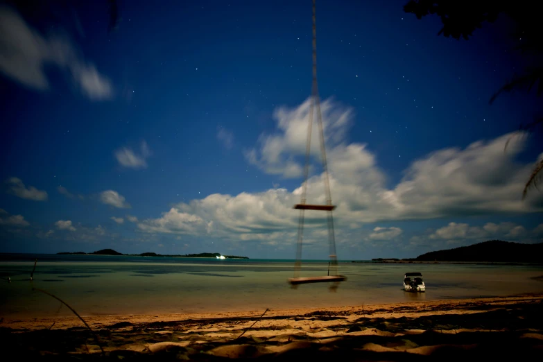 a sail boat is in the shallow water