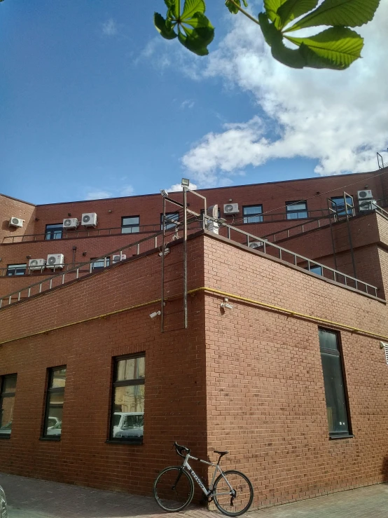 a bicycle is parked against a brown brick building